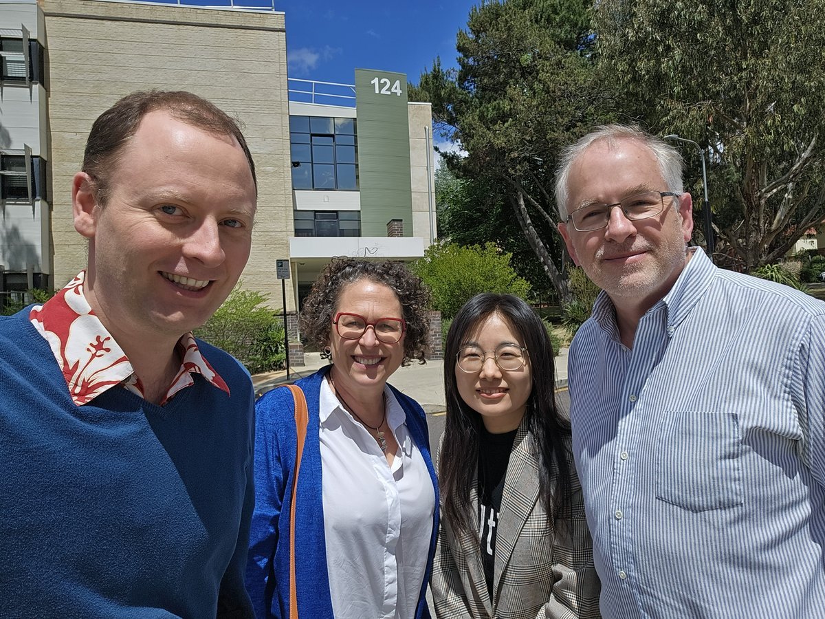 Professors Paul Burke and Jane Golley, Xueting Jiang and David Stern smiling together outdoors on a sunny day on the ANU campus