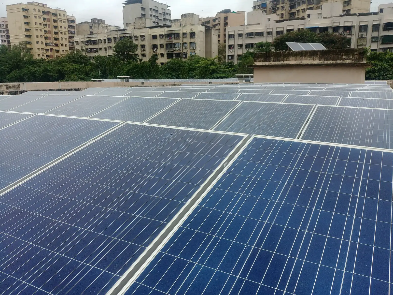 Rooftop solar panels with the city in the background