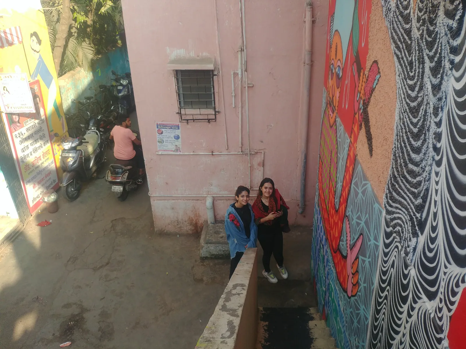 Colourful awareness mural painted on a wall in a community lane